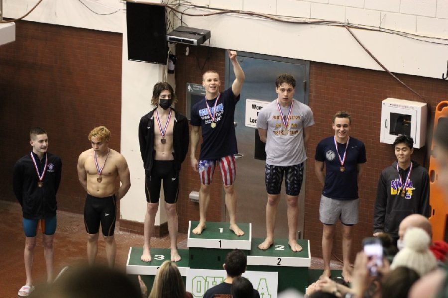 Alex Gallagher stands on the podium after winning the 200 IM at the OSHAA Northeast District meet. 