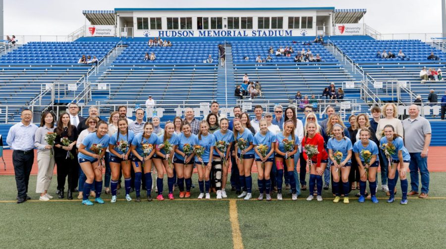 The seniors pose with their teammates and family members during Senior Night. 