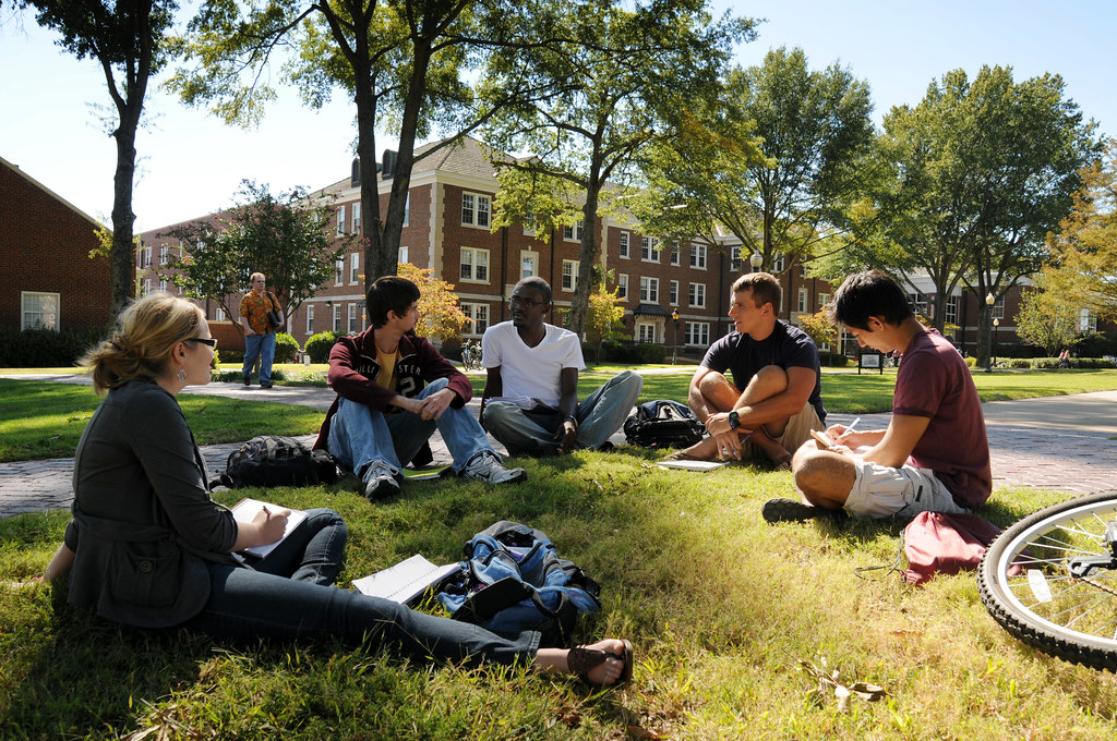 College students gather in a circle on their universitys campus. Used with permission/Flickr/University of Central Arkansas.