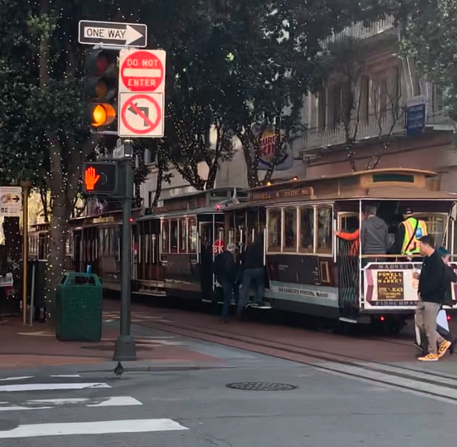 The San Francisco cable cars collect at the end of Powell Street, waiting for more customers. Tickets for a one-way ride are $8.