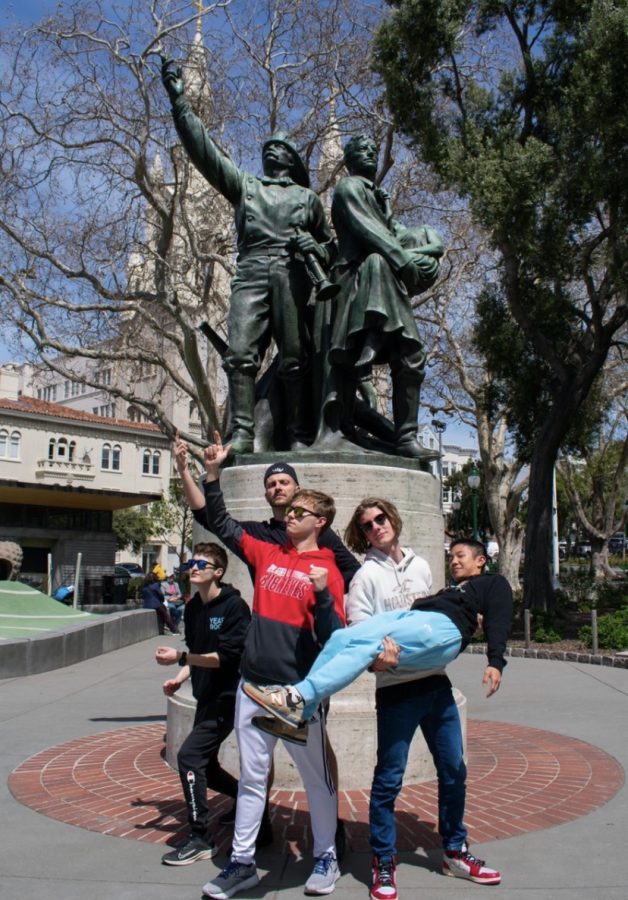 In Washington Square near Little Italy, a group imitates the Fireman's Memorial. 