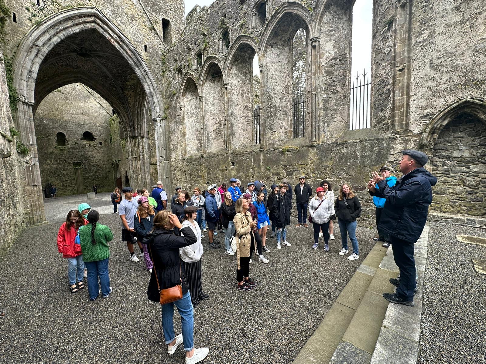The group learns about the history of the Rock of Cashel while standing inside the historic area. Used with permission/Jacob Moore.