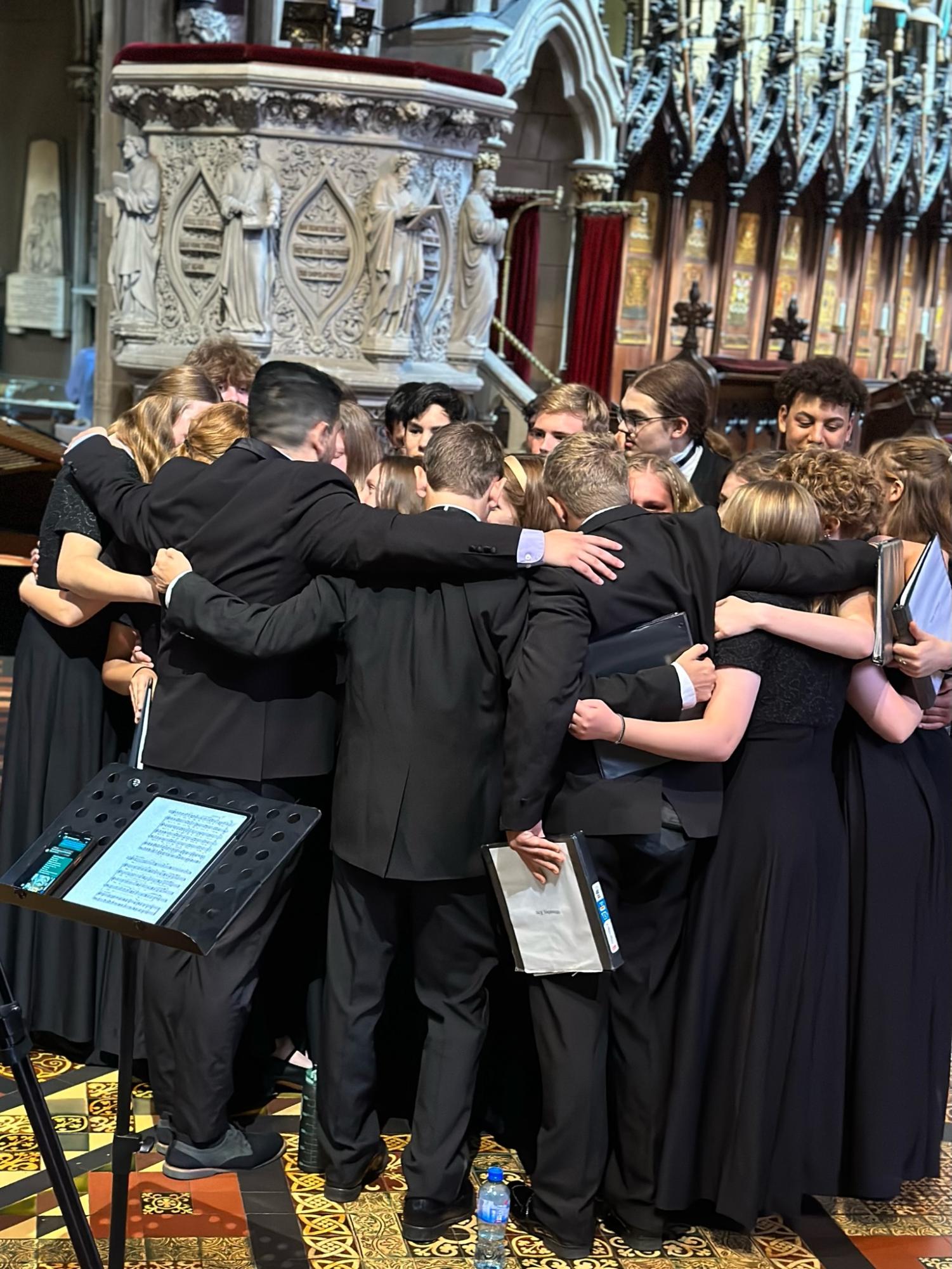 The Chamber Choir shares a touching moment at the end of their last concert together at St. Patricks Cathedral. Used with permission/Gretchen Fritsch.