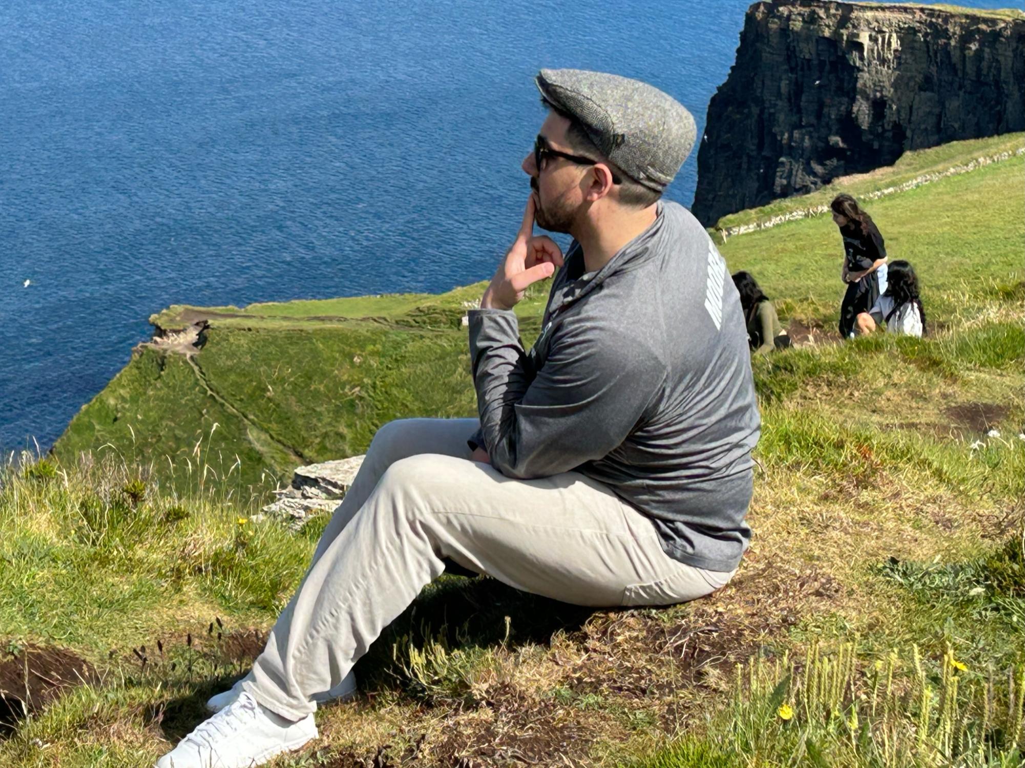 Choir Director Mr. Moore ponders his life choices while viewing the open water at the Cliffs of Moher. Used with permission/Penny Mouse.