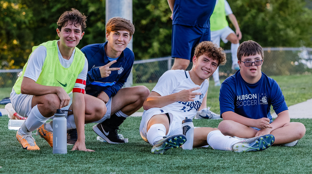 Senior Captain Gavin Mertes, senior Aidan Lawrence, junior Andrew Hensley and senior Team Manager Nick Savelli posing for a picture on the sidelines against North Canton Hoover. The team would go on to lose to Hoover for one of their three losses.