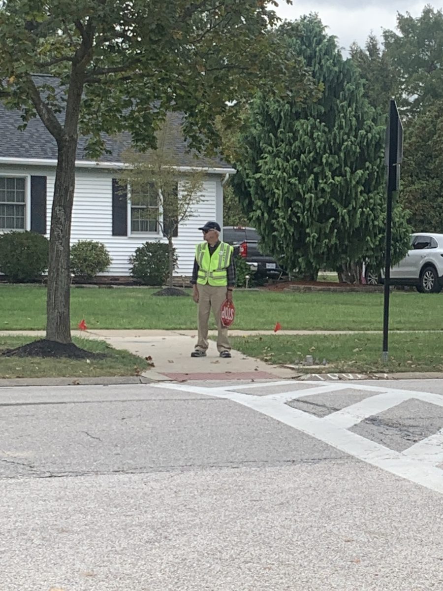 Clark Rumiser standing ready to help cross children with his stop sign in hand