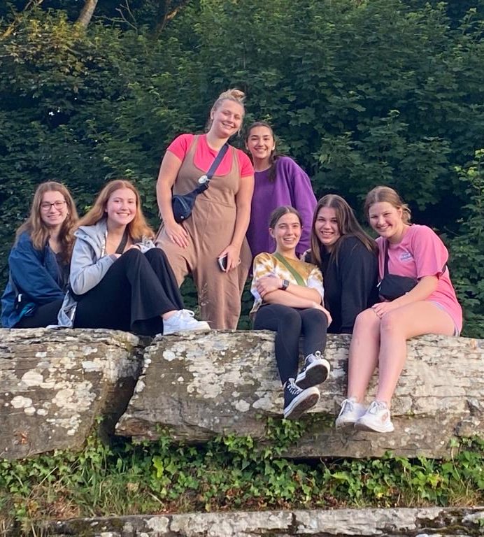 Some sopranos and altos of the choir pose on a rock in Ennistymon.