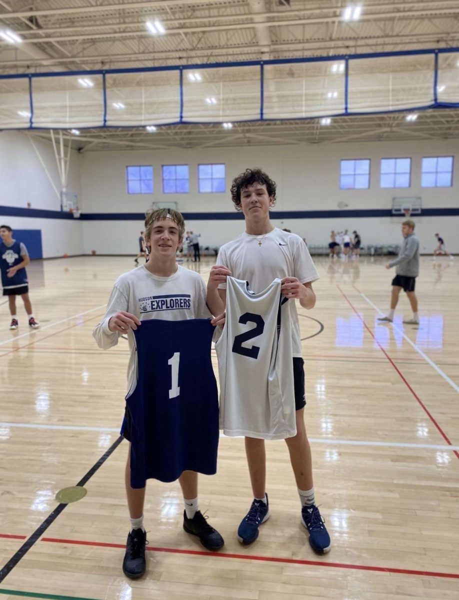 Seniors Jonah Mikolay and Max Reynolds taking a photo after playing a basketball game. Jonah’s team won the game 73-68.
