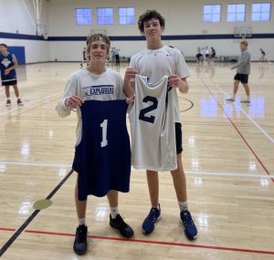 Seniors Jonah Mikolay and Max Reynolds taking a photo after playing a basketball game. Jonah’s team won the game 73-68.