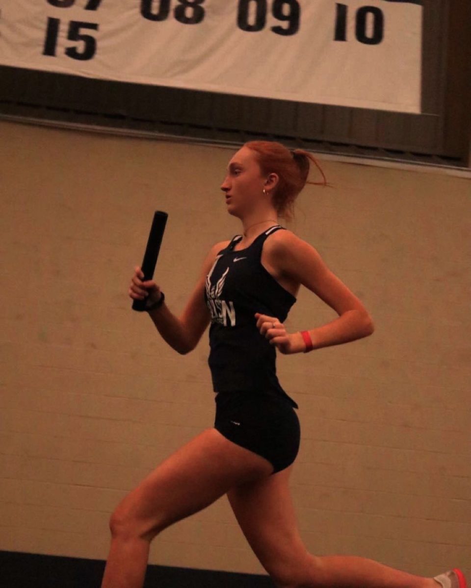 Senior Ellie Gallagher races to finish in a relay race during the 2022 season. Gallagher hopes to shatter her personal best this season. Used with permission/Ellie Gallagher.