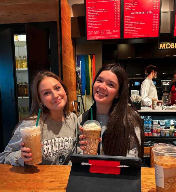 Sophomores Sammie Bielecki and Adalyn Gibson, hold up their favorite holiday Starbucks drinks, the Iced Caramel Brulee Latte and the Iced Sugar Cookie Almond Milk Latte.