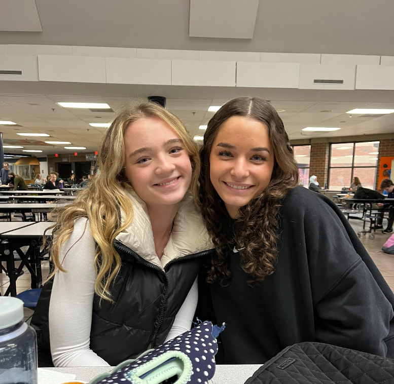 Julia Meese and Gabi Censoprano pose for a picture. After working hard for the Holiday Sharing Drive on November 21st, Meese and Censoprano took a break to eat lunch in the Commons before returning to Student Government.