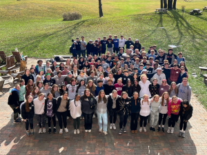 The 2023 Leadership Conference members take a photo in the middle of Camp Asbury.