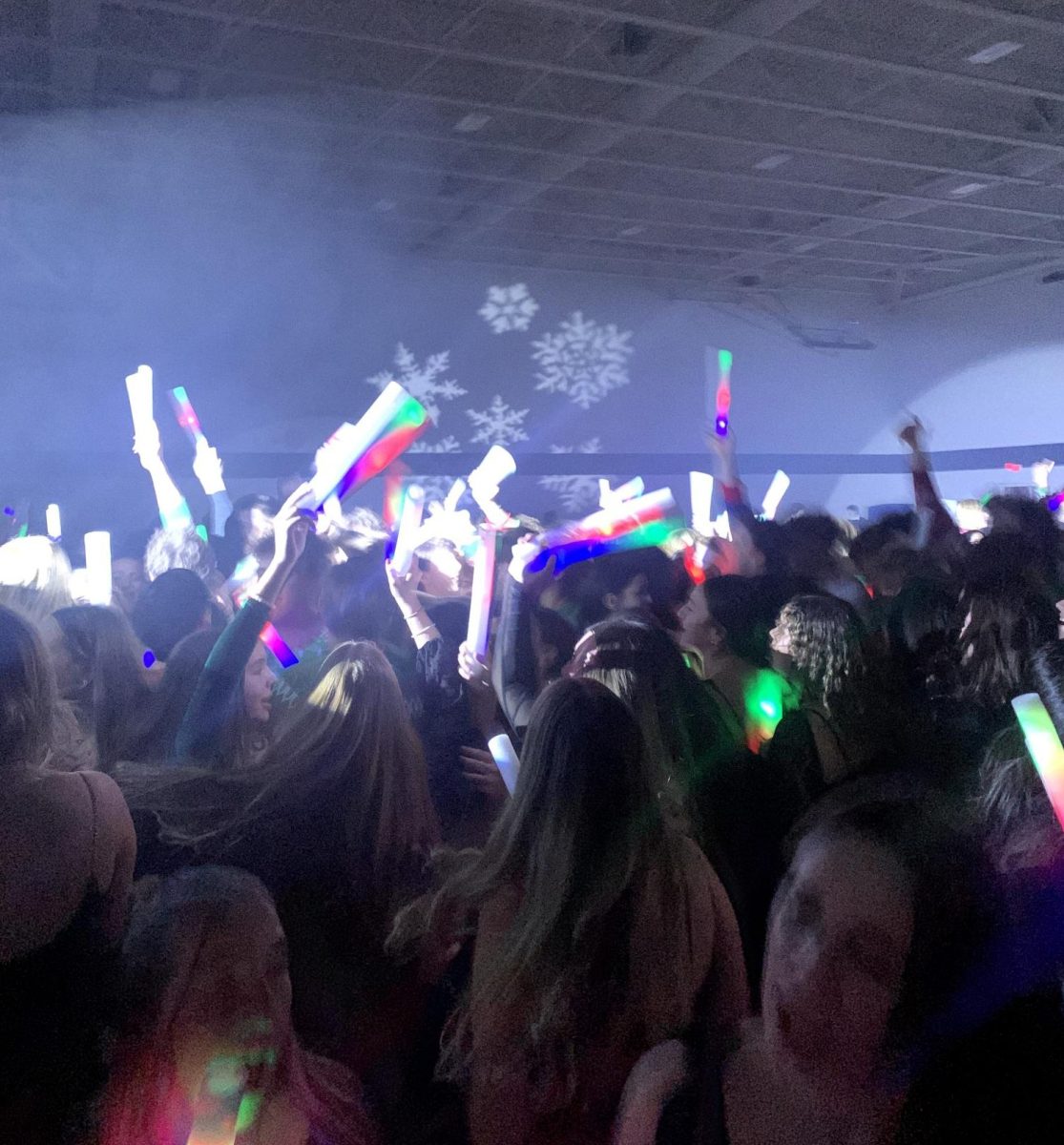 Hudson+students+jump+to+the+music+with+their+foam+glow+sticks+at+the+2023+Winter+Formal+Dance.