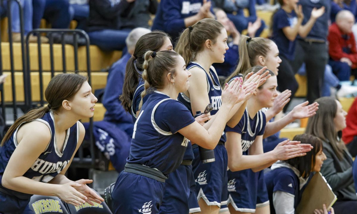 The Hudson varsity girls’ basketball team clapping and supporting their team during a game against the Painesville Beavers. The team are each other’s strongest supporters, always there to encourage fellow players to victory. Used with permission/Ken Klemencic.