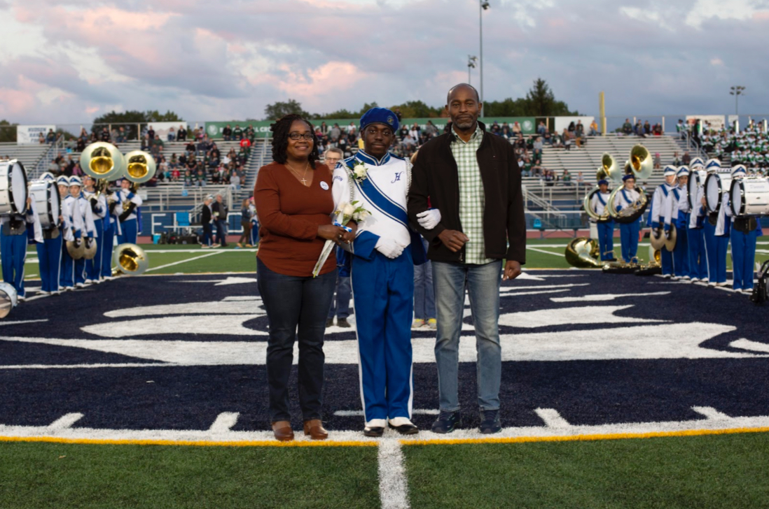 Louis walks down HHS’s Memorial Field with his parents during Senior Night. On this special night, the Marching Band members and spectators honor seniors like Louis for participating in band during his senior year of high school.