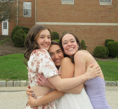 Alicia Hoppes, Sunita Bhatia and Katie Bielecki at their senior Sadie Hawkins dance. The three best friends share their last dance together and embrace in a hug.