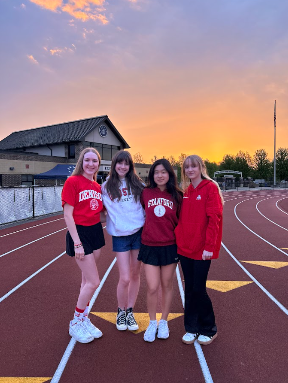 Lily Arigo, Greta Knipe, Erica Liu and Ella Smetham at Senior Sunrise in their college gear. Knipe and Smetham will be at Ohio State in the fall, while Arigo is going to Denison and Liu is headed to Stanford. Used withpermission/Greta Knipe.