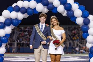 Senior Libby Thomas and Joey Herman walk down center field during halftime of the Homecoming Football game.
