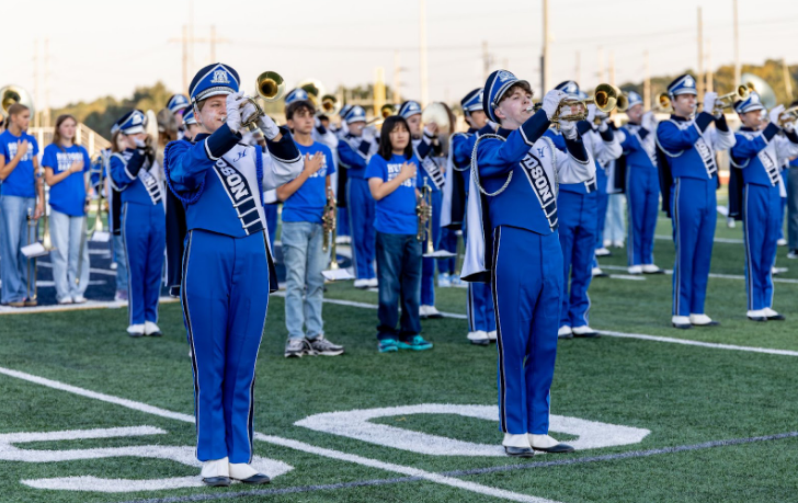 Senior trumpet soloists Magnolia Dryden and Isaac Albertson perform the national anthem during the Hudson High School Swing Marching Band's pre-game show before the football team takes on Solon.