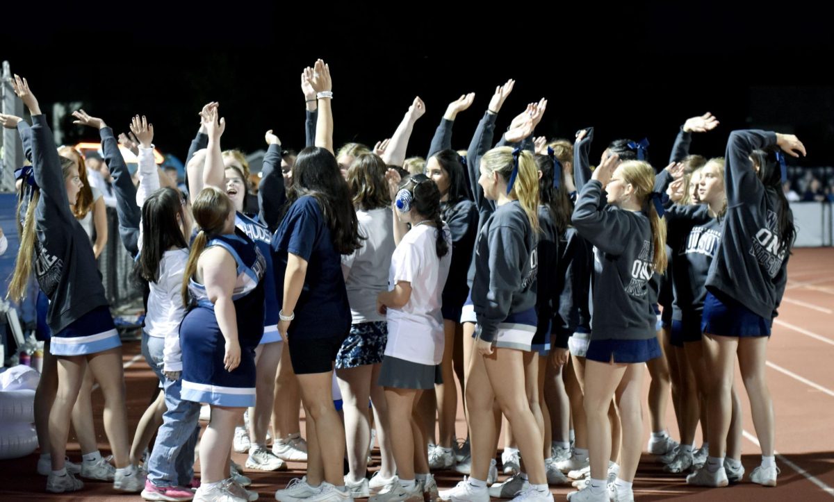 Sparkle Cheer huddles together for a final “hands in” after the Sept. 12 football game against Solon, celebrating with high energy and big smiles following the team’s big win.