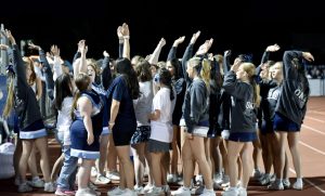 Sparkle Cheer huddles together for a final “hands in” after the Sept. 12 football game against Solon, celebrating with high energy and big smiles following the team’s big win.
