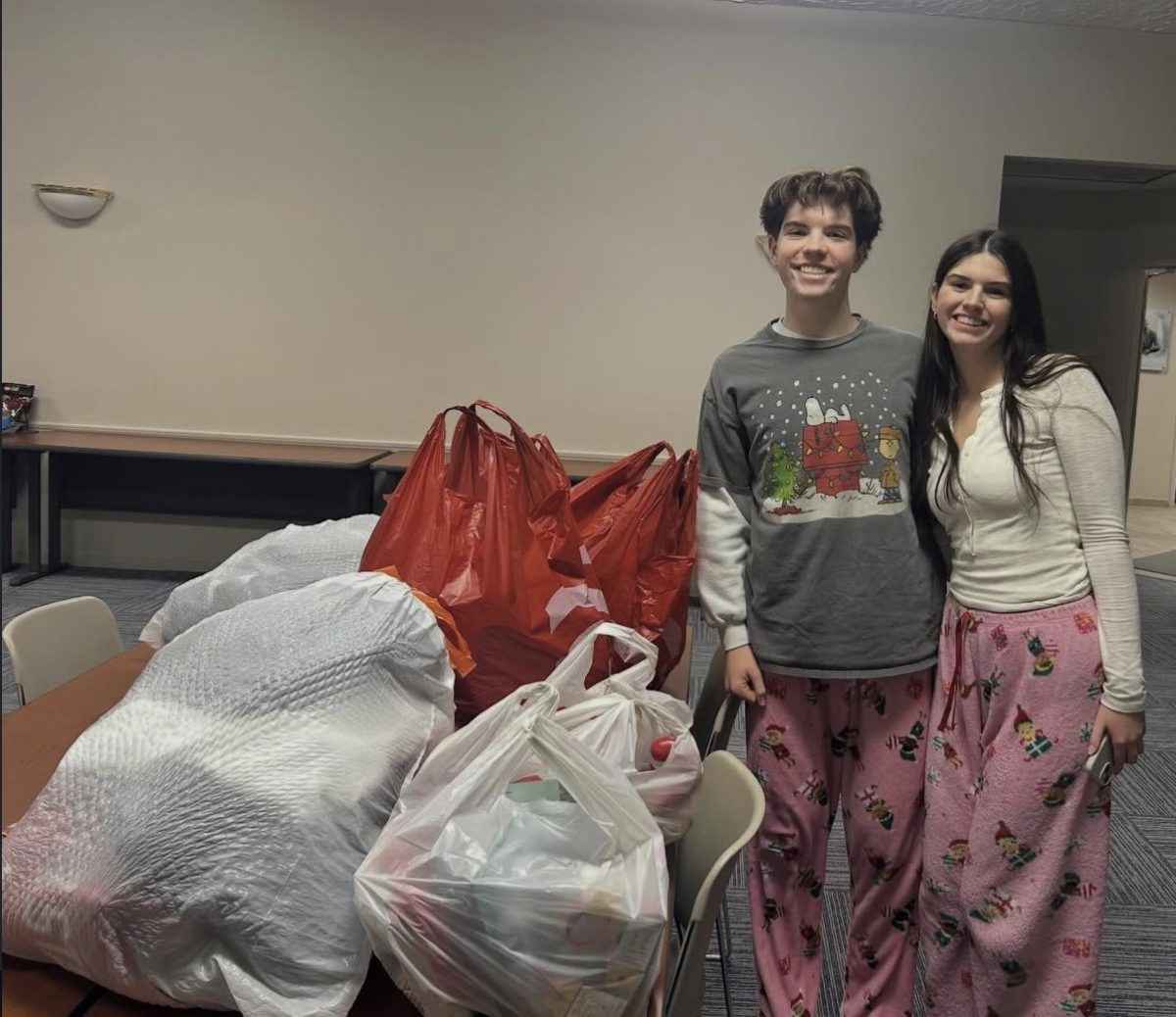 Club presidents Joey Herman and Paige Masi pose in front of a multitude of bags filled with different pieces collected from the club’s clothing drive. The clothing drive is an annual event hosted by the club, all donations go directly to a teen shelter in Akron.